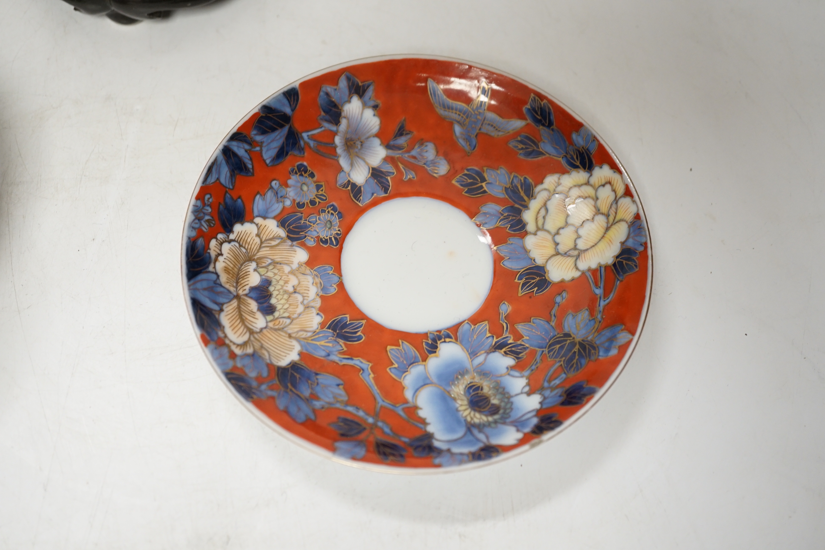 A Chinese famille rose vase, a rice dish, saucer and wooden stands